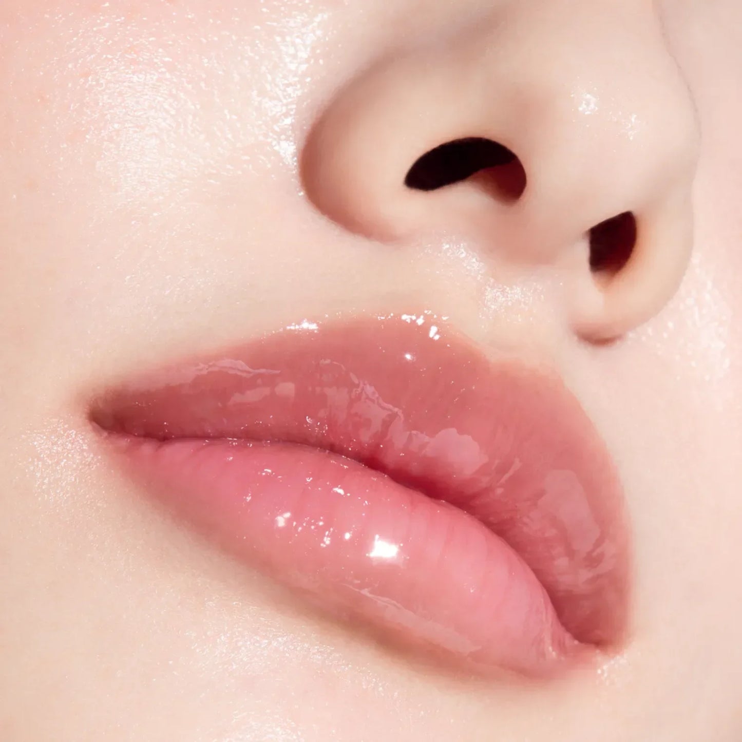 Glossy pink lips with dewy skin, showcasing Korean beauty hydration and natural glow